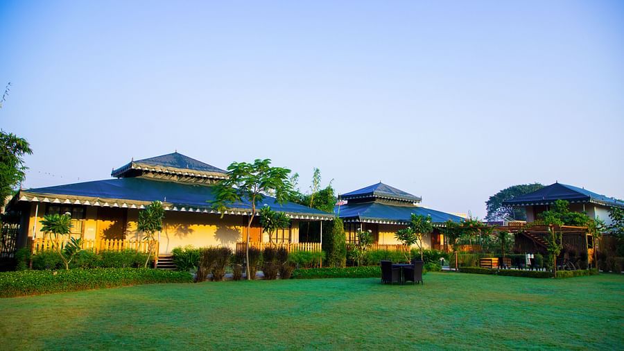 A facade image of The Baagh Ananta Elite, Ranthambore with a lawn in front