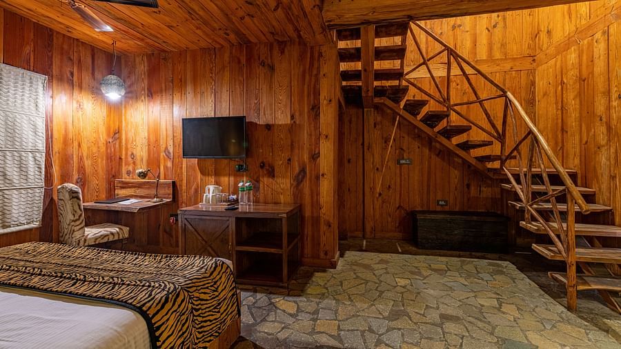 one of the duplex cottages in Ranthambore with a bed at one corner 4