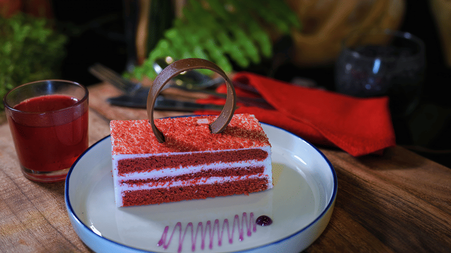 A well-decorated cake placed on a plate at Clarks Hotels.