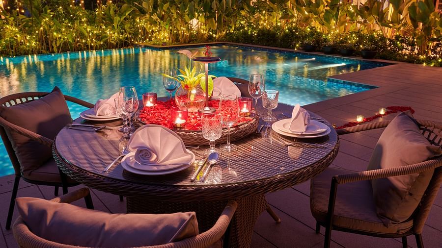 dining setup beside the swimming pool, adorned with glowing candles for an intimate evening at The Dukes Retreat  