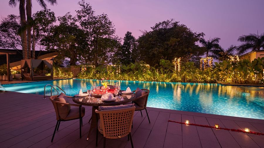 Special dining setup by the swimming pool with candles at The Dukes Retreat