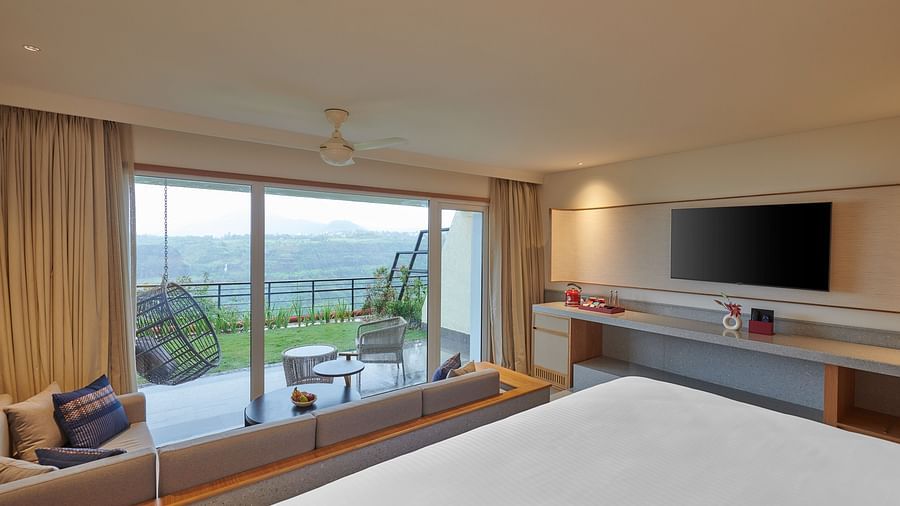 Image of a room with a king size bed and a seating area outside overlooking the valley at The Dukes Retreat.