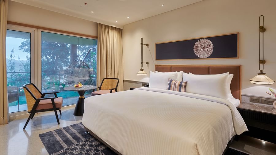  Image of a room with a king size bed and large windows on the side at The Dukes Retreat.