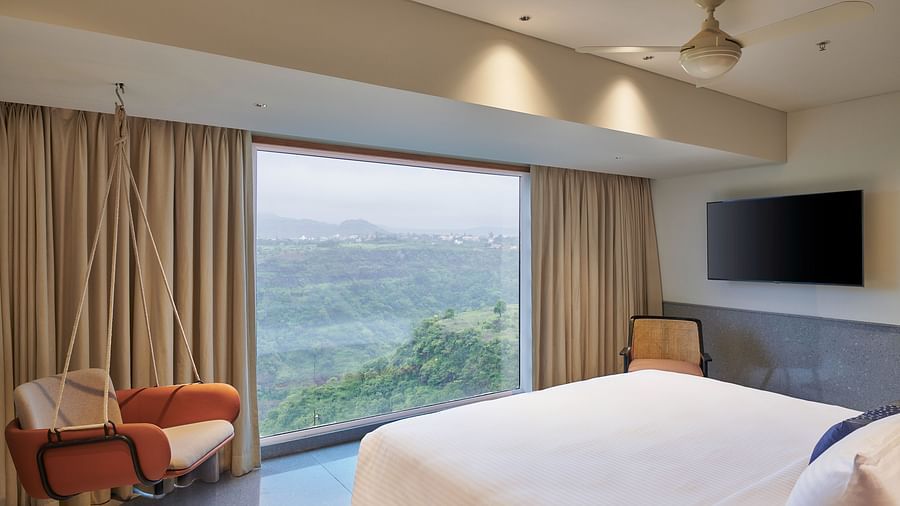 Image of a room with a bed and a large window in front overlooking the valley - The Dukes Retreat, Khandala