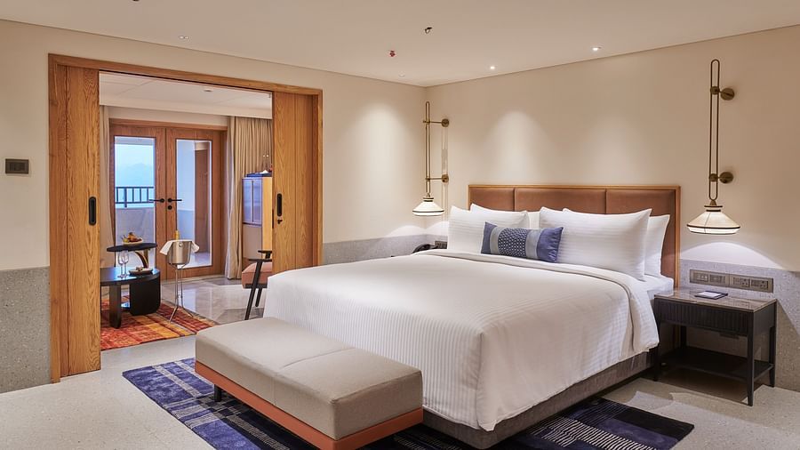 Image of a bedroom with a king size bed and a bed bench in front of it - The Dukes Retreat, Khandala