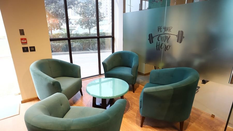 A lounge area at The Gaurs Sarovar Premiere, with comfortable couch and tables.