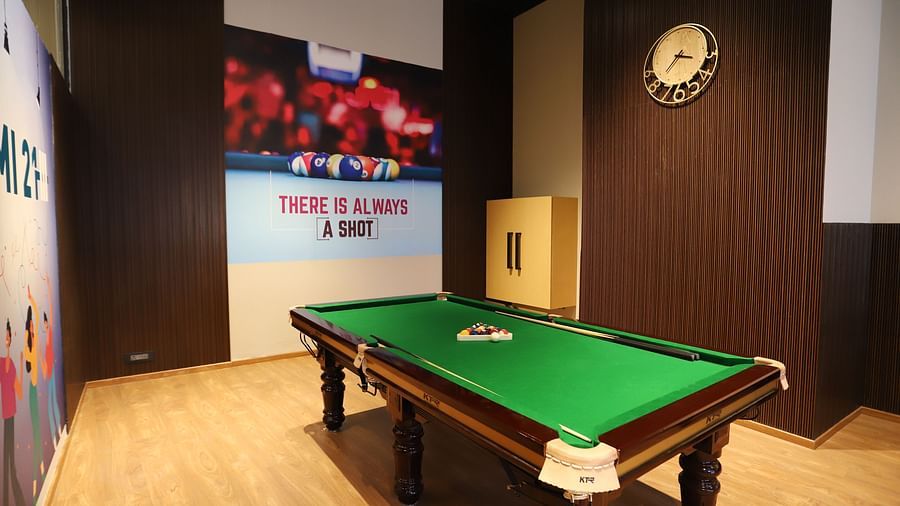 A billiards room at The Gaurs Sarovar Premiere, with a green billiards table.