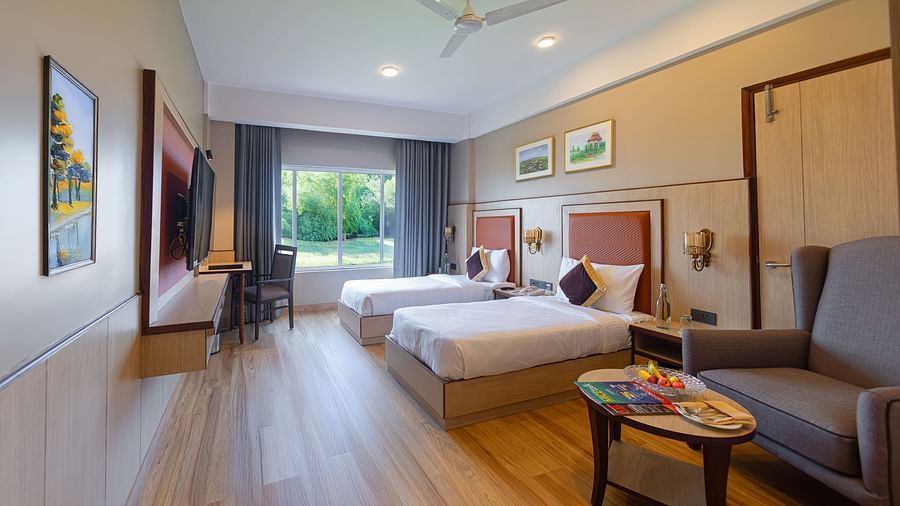 Spacious hotel suite at The Lalita Grand, with work area.
