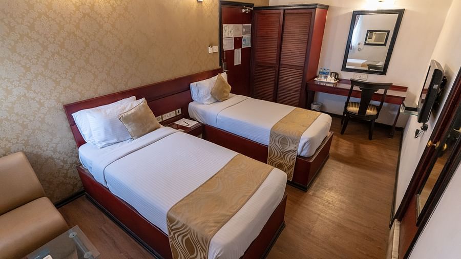 An image of a bedroom with two single size beds - The Lindsay