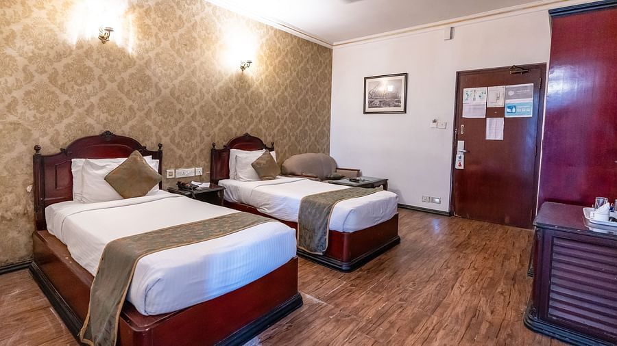 An image of a bedroom with two beds - The Lindsay