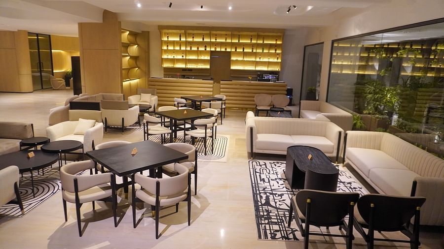 Relaxing hotel lounge area furnished with comfortable sofas, stylish armchairs, and small tables, situated by large windows that bring in ample daylight - The Orchid Hotel, Chandigarh