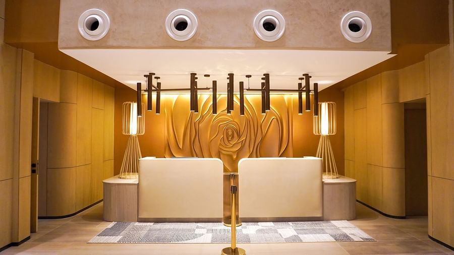 A reception featuring ceiling lights hanging from top, below there is a reception desk - The Orchid Hotel, Chandigarh