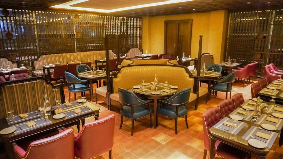 Intimate restaurant corner offers plush armchairs around tables with soft lighting creating a cosy feel - The Orchid Hotel, Chandigarh