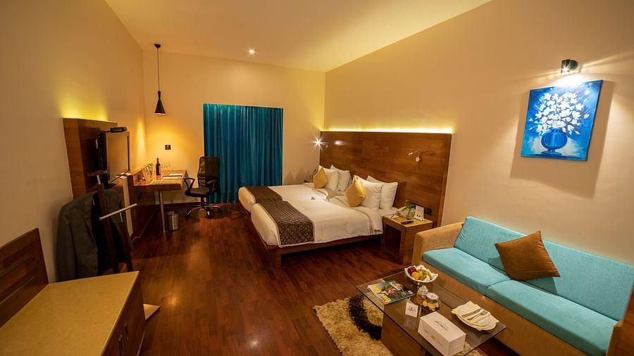 a full view of a room with bed and sofa  2 - The Orchid Hotel Pune