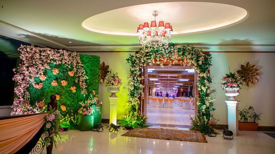 The interiors of a decorated venue hall featuring flower arrangements - The Orchid Hotel Shimla