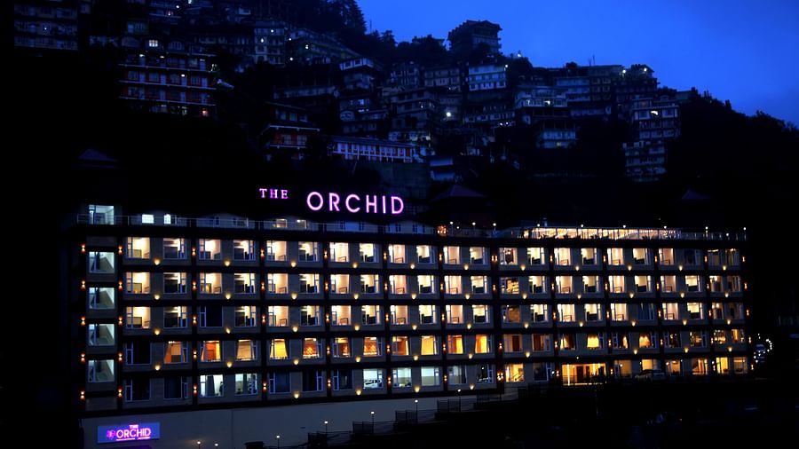 The facade of the Orchid Hotel Shimla at night with every window lit up from the inside - The Orchid Hotel Shimla