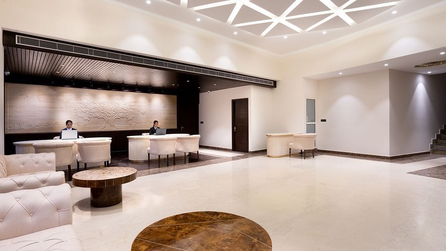A spacious lobby with pristine white furnishing - The Orchid Hotel Shimla