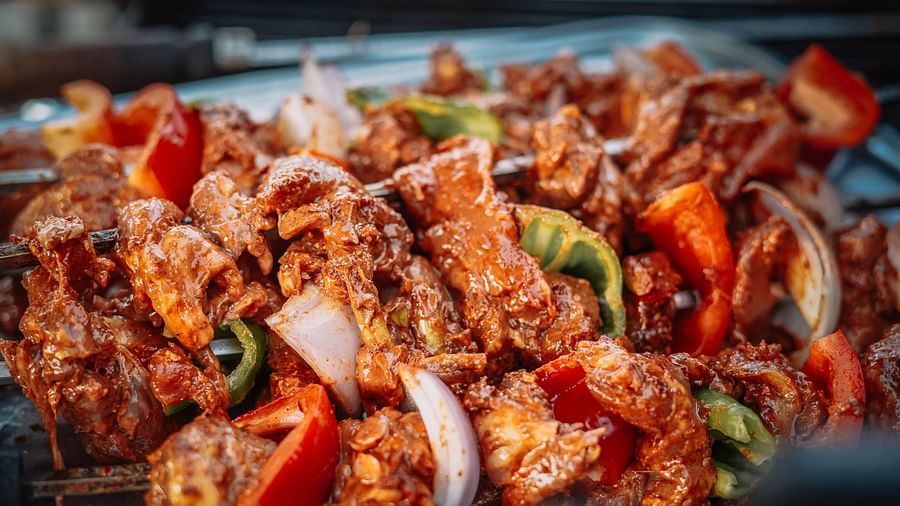 chicken grilled along with veggies on a skewer