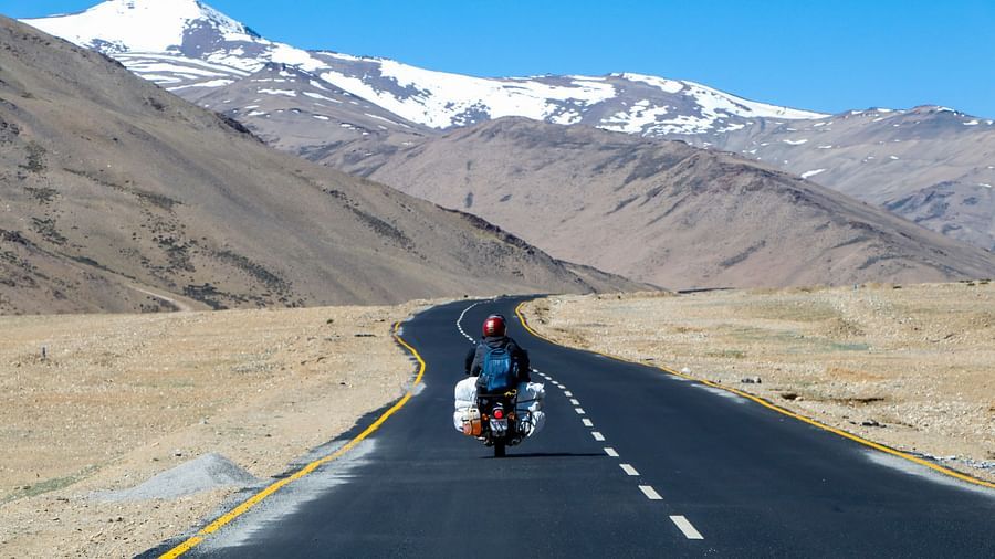 Man riding on the bike amidst the mountains