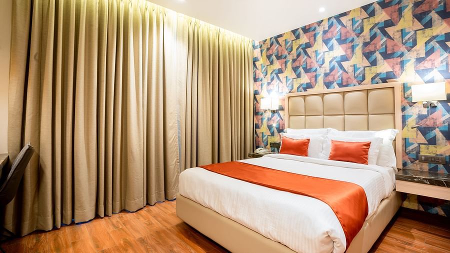 bedroom of one of the Deluxe rooms at The Orchid Lonavala 12
