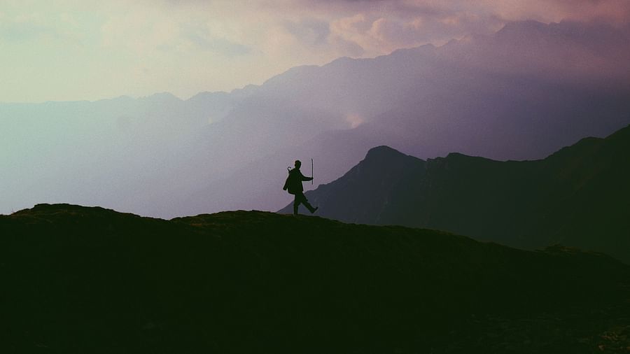 Eye view of the mountain and a person standing and enjoying the view