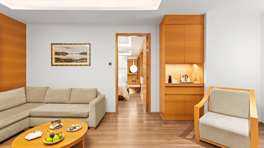 Club Suite room with a cozy sofa and a round table at The Residency Towers Coimbatore