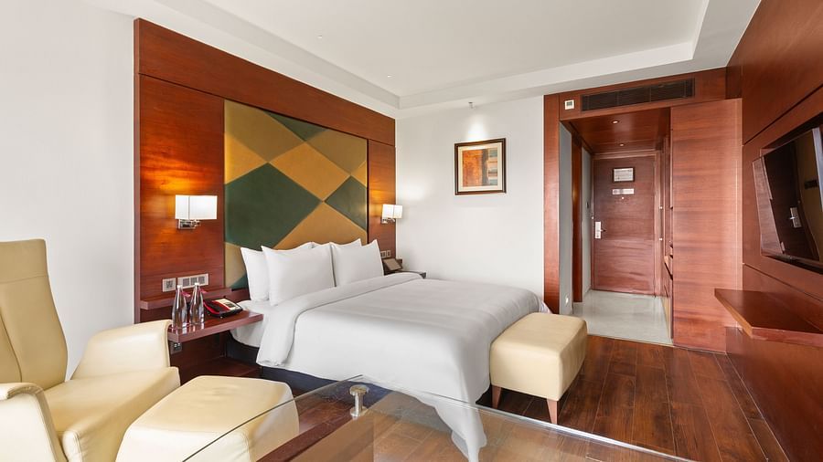 Executive Room with a cozy bed and bedside lamps at The Residency Towers Coimbatore