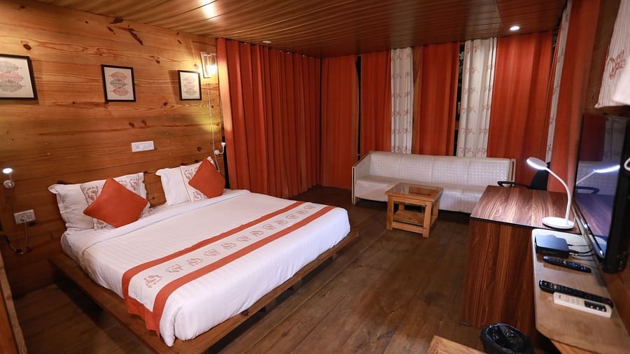 double bed and amenities in the Deluxe Cottages at The Sal Woods Forest Resort & Spa