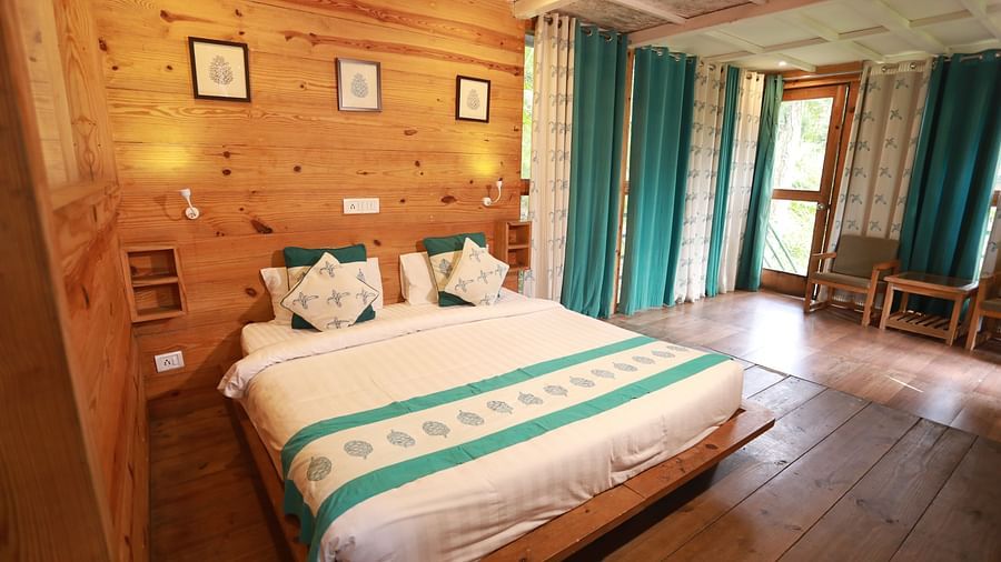 double bed and amenities in the Superior Cottages at The Sal Woods Forest Resort & Spa