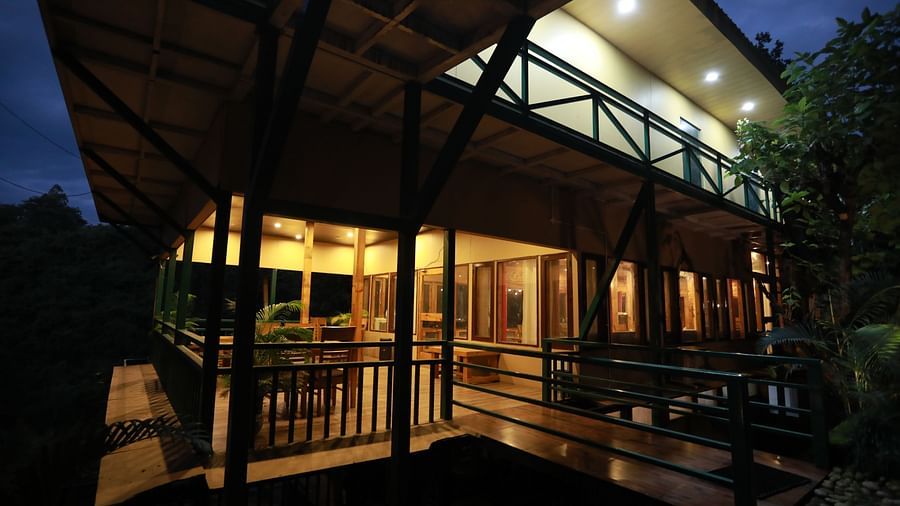 one of the cottages at The Sal Woods Forest Resort & Spa lit up at night