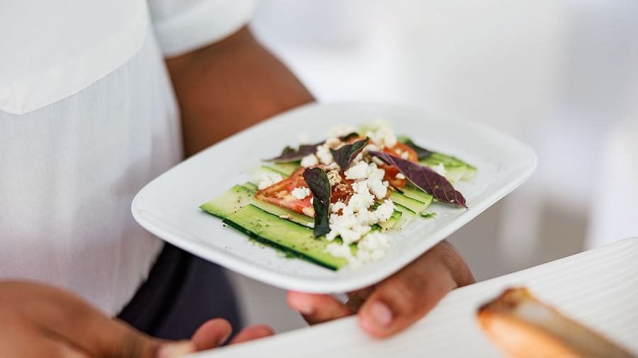 a waiter serving food - The Soco House
