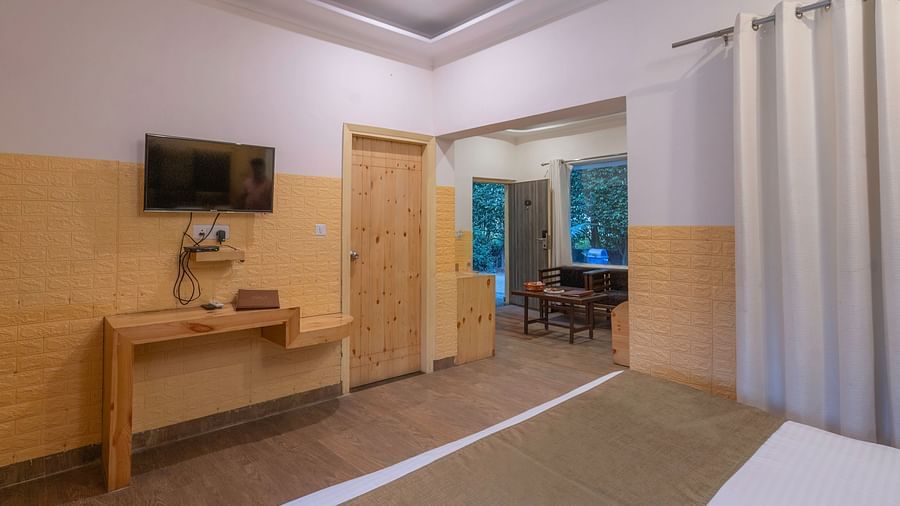 Spacious guest room with modern amenities at The Tattwaa Corbett Spa & Resort.