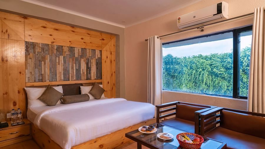 Room with sofa seating and scenic view at The Tattwaa Corbett Spa & Resort.