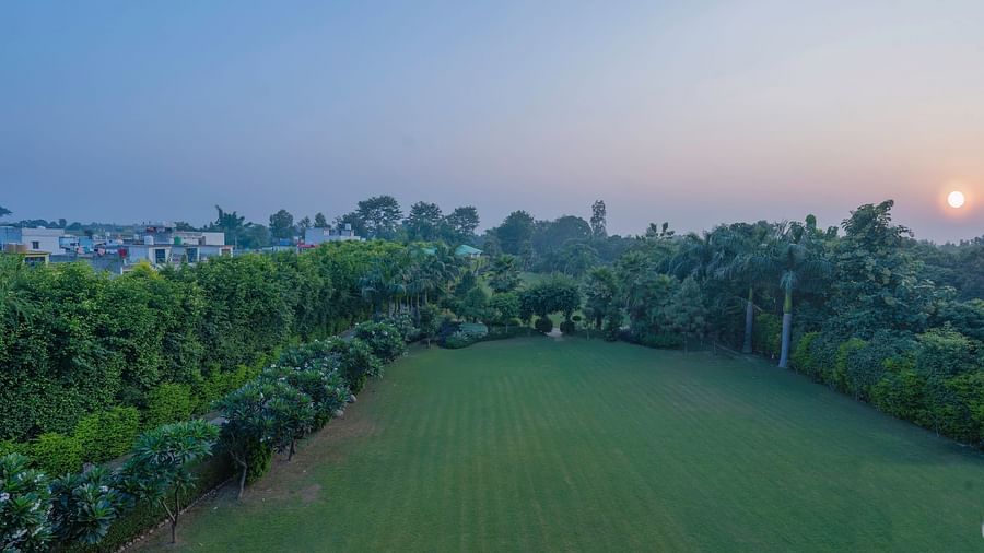 Expansive green lawn with scenic views at The Tattwaa Corbett Spa & Resort.