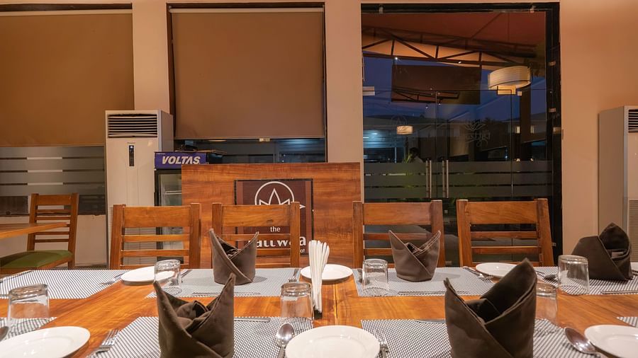 Dining area with large windows at The Tattwaa Corbett Spa & Resort.