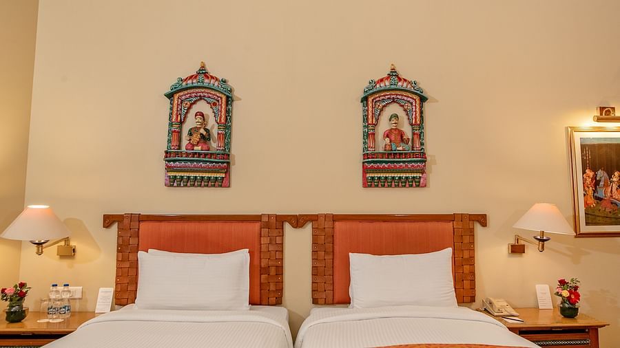 Luxurious twin-beds in a room with bedside lamp shade and aesthetic interior - The Ummed Jodhpur, Palace Road and Spa