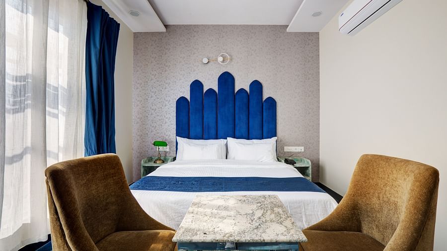 Superior Deluxe Room with blue themed interior and blue & white curtains - The White Moon