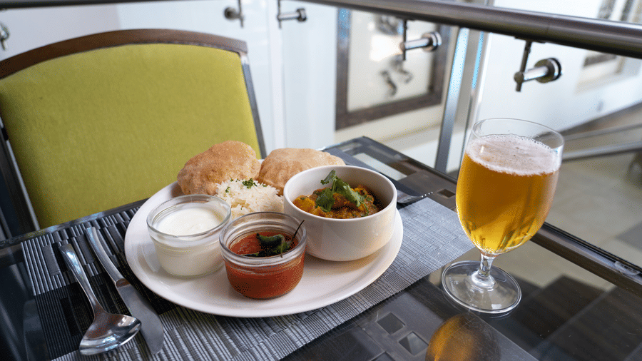 Breakfast tray with snacks and a chilled drink on the balcony seating at The Zehneria, Nairobi