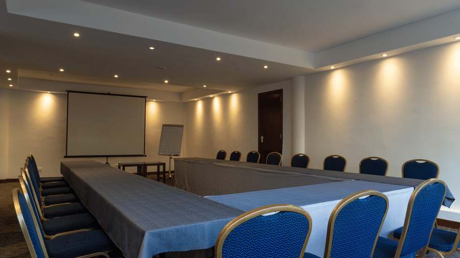 Conference room with projector screen and meeting tables at The Zehneria, Nairobi