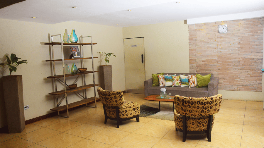 Relaxed reception area with wicker furniture at The Zehneria, Nairobi