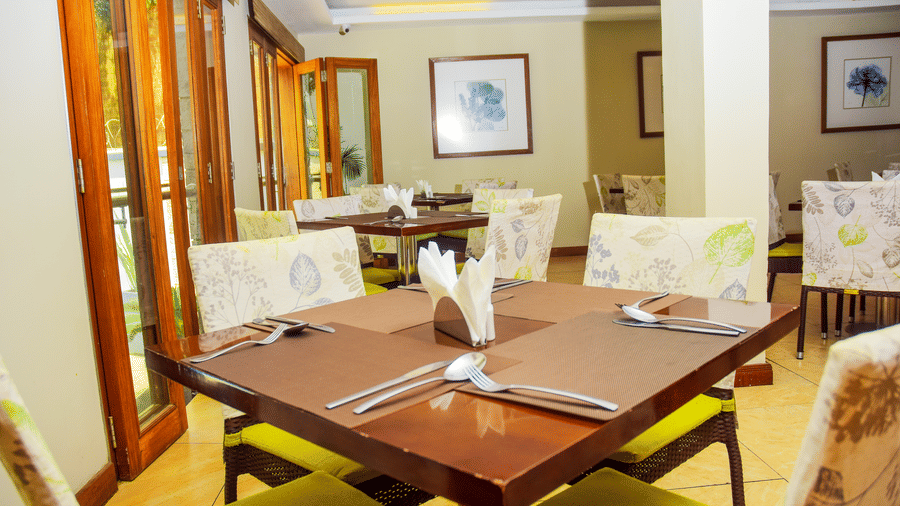 Elegant indoor dining table setup with natural light of the Seasons Restaurant at The Zehneria, Nairobi.