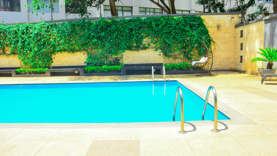 Outdoor swimming pool with greenery backdrop at The Zehneria, Nairobi