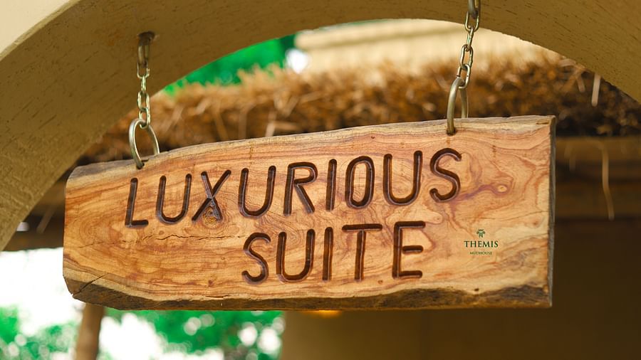 a board displaying Luxurious Suite at Themis Mudhouse - A Nature's Retreat Resort & Wellness