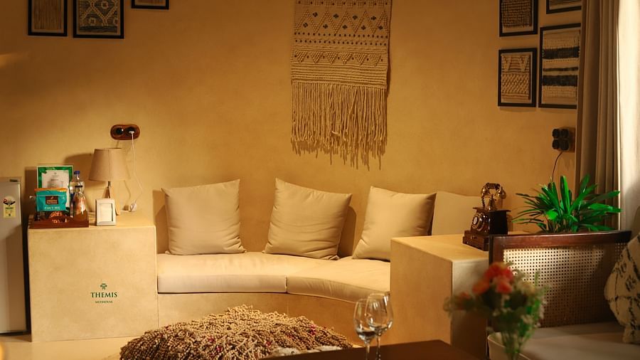 interior of the villa focusing on the sofa with soft cushion at Themis Mudhouse - A Nature's Retreat Resort & Wellness