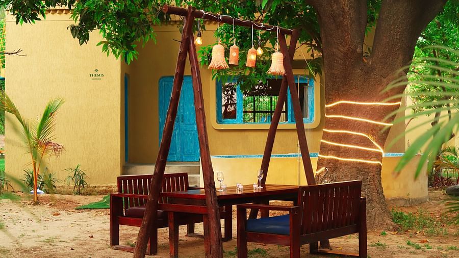 outdoor patio with seating arrangement at Themis Mudhouse - A Nature's Retreat Resort & Wellness