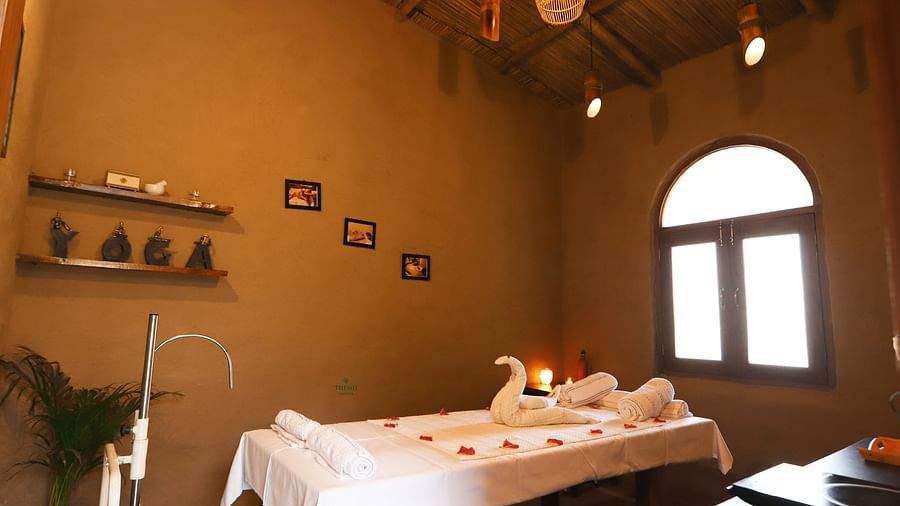 Themis Medival Wellness Centre displaying a massage table and rustic interior at Themis Mudhouse - A Nature's Retreat Resort & Wellness