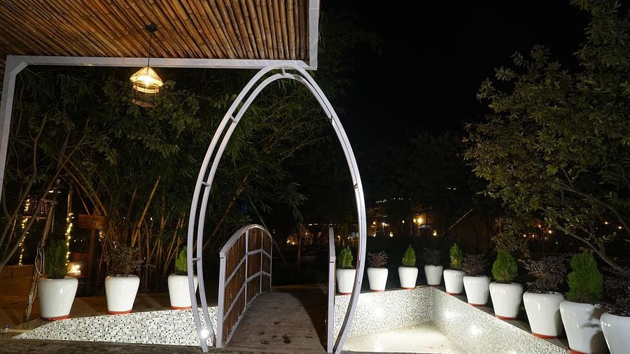 Night view of a garden with flower pots  at Themis Mudhouse Nature Retreat Resort