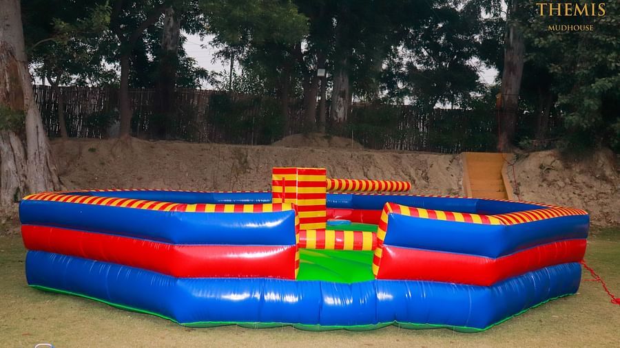 Inflated trampoline surrounded by trees at Themis Mudhouse - A Nature's Retreat Resort & Wellness