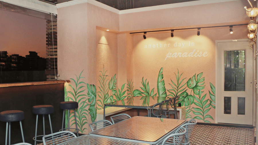 An open air dining area with wooden floor panelling and warm lighting.