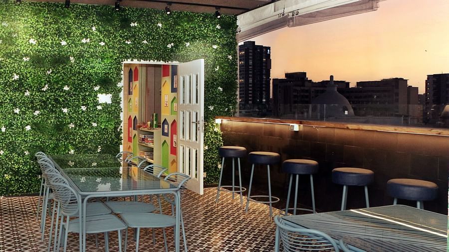An image of a dining area in balcony offering the mesmerising views of the city